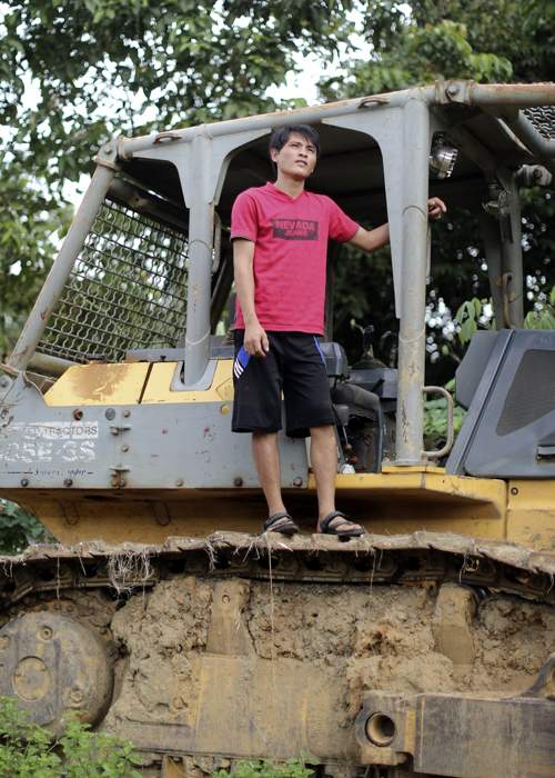 Franly Oley standing on top of a bulldozer taken hostage by villagers from Merabu after they contested the right of a rival village to plant palm oil crops on disputed land