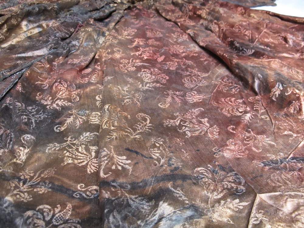 Detail of 17th-century embroidered silk dress recovered from the Wadden Sea. ©Emmy de Groot \/ Kaap Skil Museum. The recovered gown is now held by the Kaap Skil Museum on the Dutch island of Texel