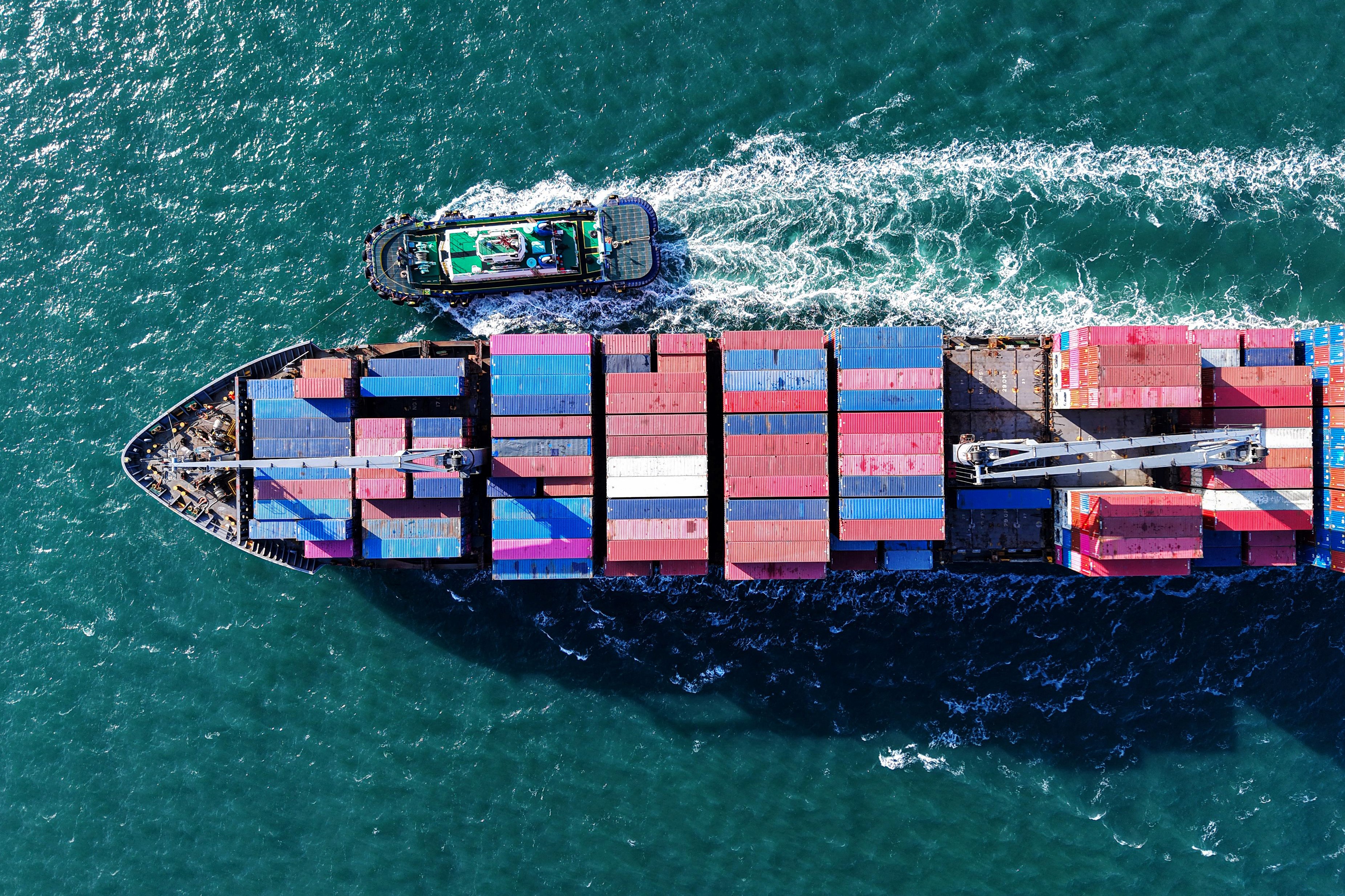 An aerial image of a container ship as it approaches a port in Qingdao, in eastern China's Shandong province