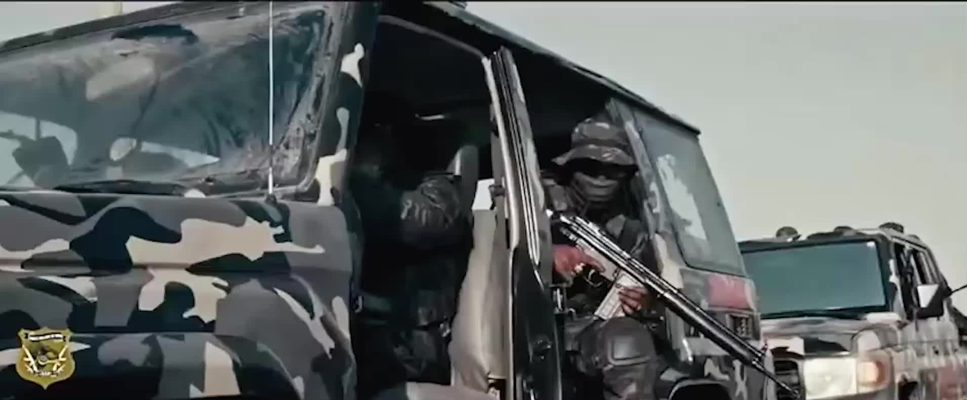 A montage of masked armed men posing with rifles and camouflaged armored vehicles.