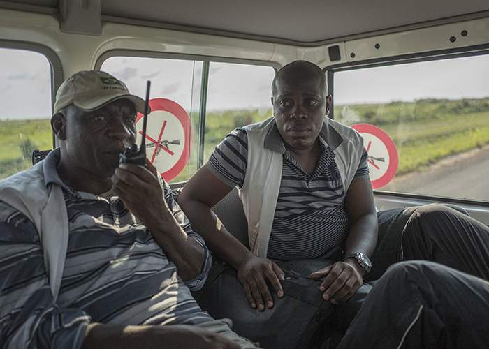 Dr Emmanuel Onoya (right) and Alphonse Ntumba learn of the passing of Felly Katembo by radio as they travel in the vehicle behind the ambulance