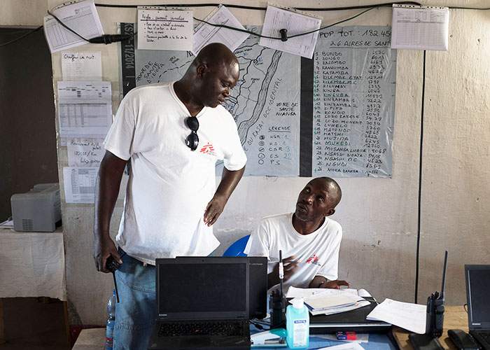 Staff monitor the typhoid outbreak using radios, computers and hand-drawn maps