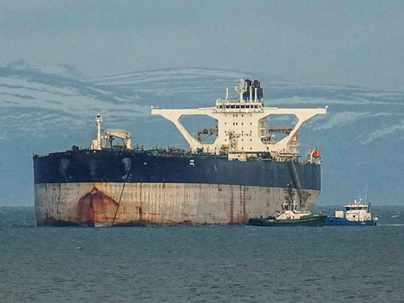 Black and white nighttime footage of the Sophia being boarded by the US military via helicopter