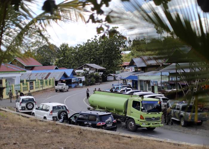 Palm oil tankers wind through the villages and towns
