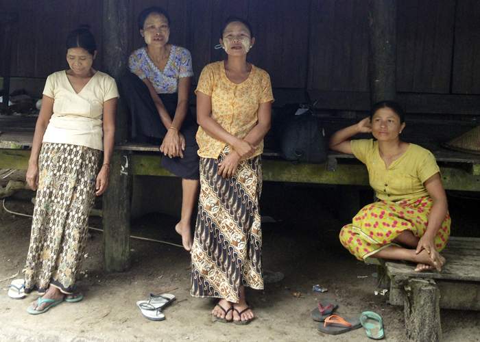 Hla Ohn May, centre, has had to take what work she can as a labourer since selling her land. She says she was never paid the amount she was promised