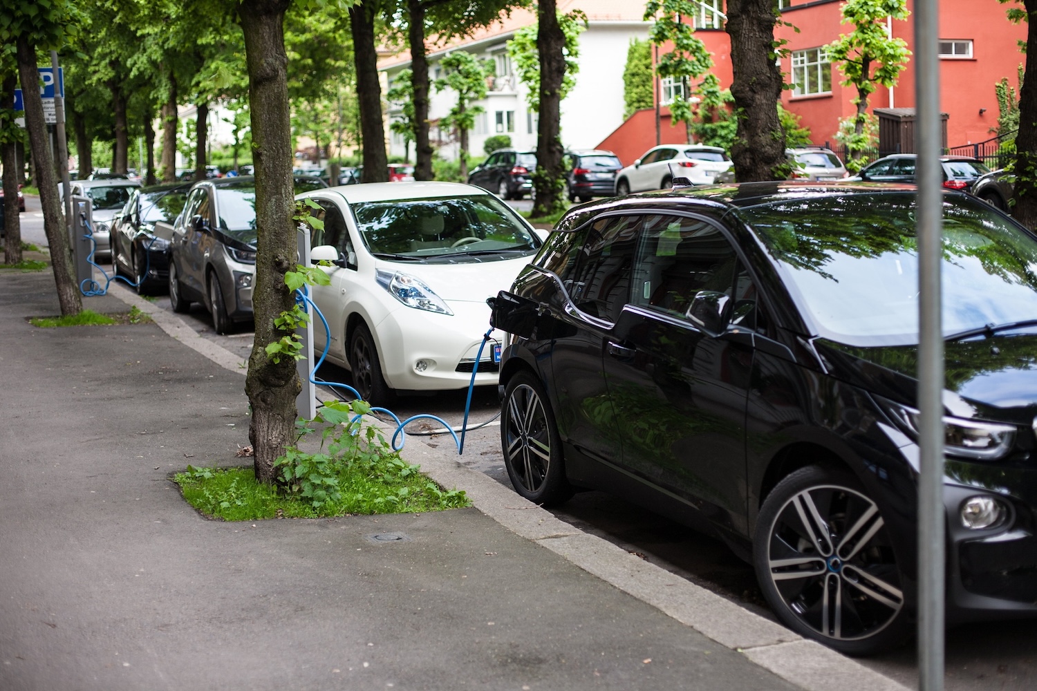 An Oslo residential street lined with cars charging at public plug-in points